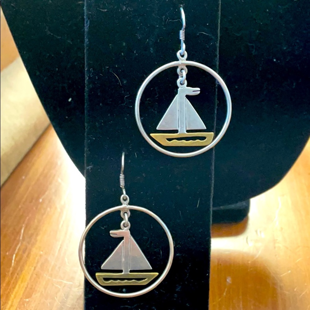 Sterling and bronze “ship” hoop earrings.